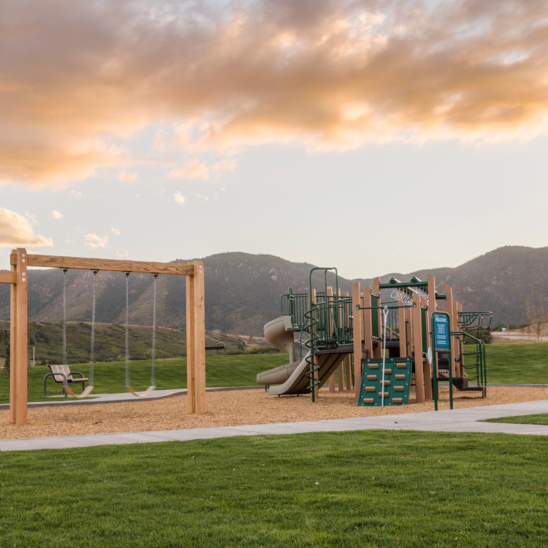 A playground in Forest Lakes Metro District with the mountains in the background